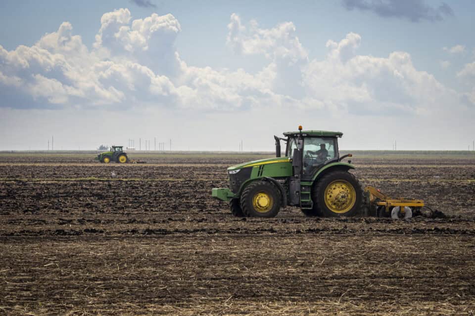 Tractors tilling the black muck soil of the Glades farming region near Belle Glade, Florida