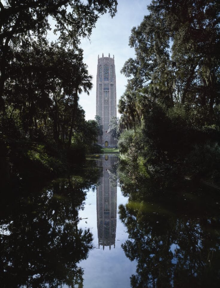 The historic Bok Tower reflected in the water at Bok Tower Gardens in Lake Wales, Florida