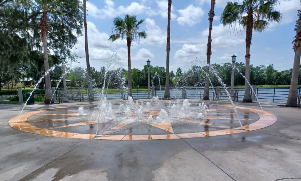 The lakefront compass-rose fountain surrounded by palms in Celebration, Florida