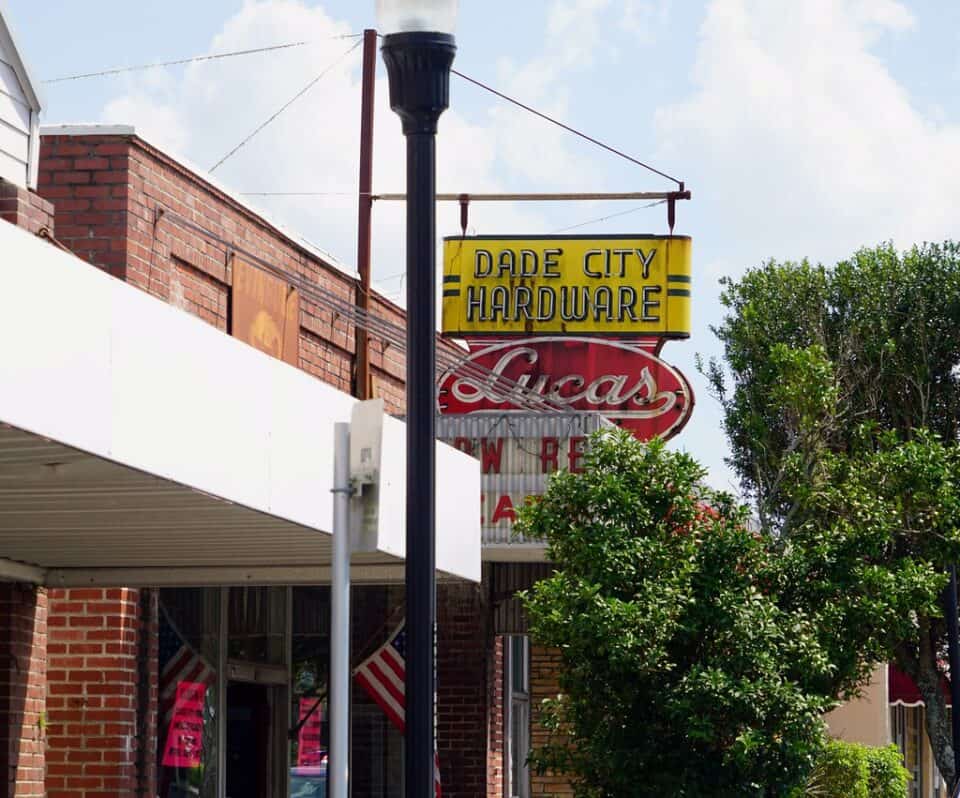 Vintage Dade City Hardware neon sign on a brick storefront in downtown Dade City, Florida