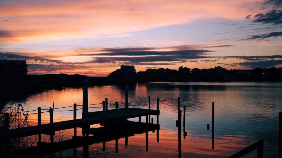 A colorful sunset over the docks of Destin Harbor in Destin, Florida