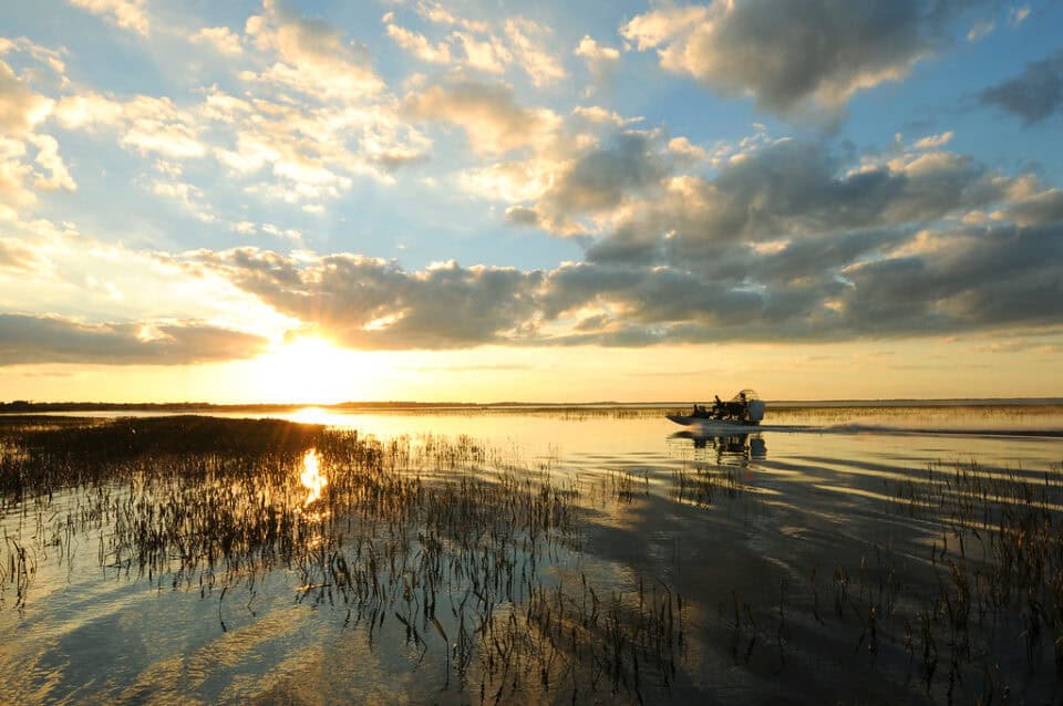 Sunrise over Lake Tohopekaliga with an airboat in Kissimmee, Osceola County, Florida