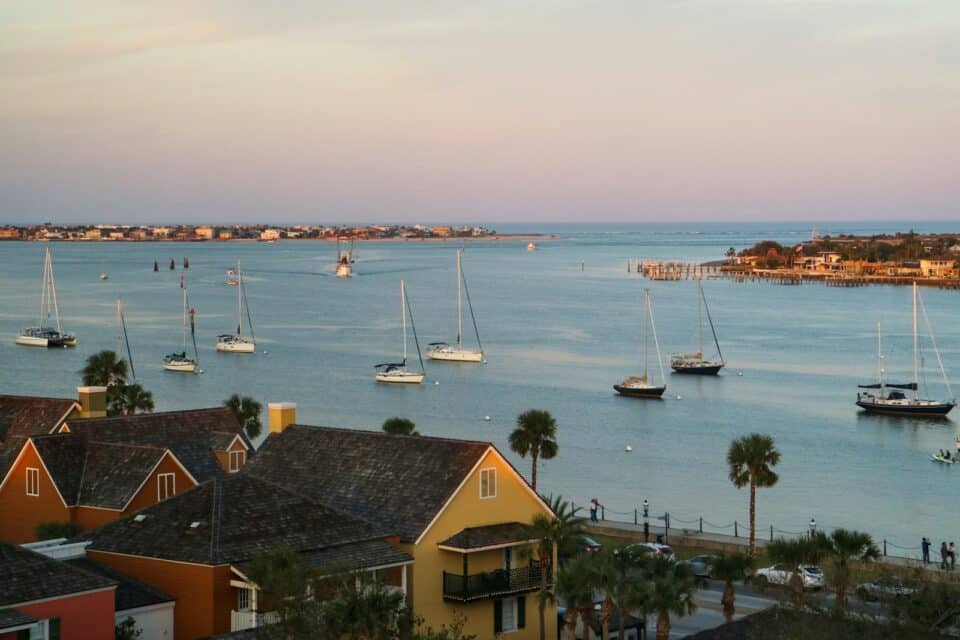 Sailboats anchored in a calm Florida harbor at dusk