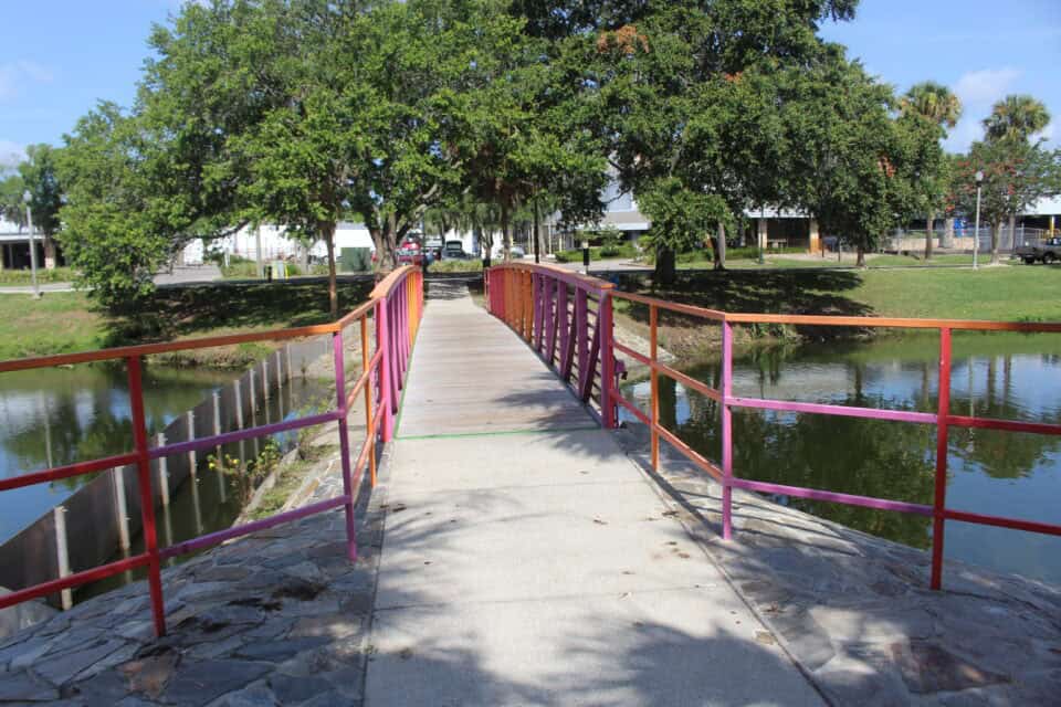 A colorful footbridge over the lake at Tuscawilla Park in Ocala, Florida
